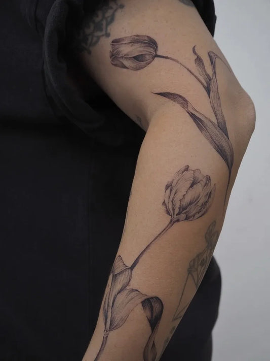 Medium Black and Grey Tulip Tattoo on Women Arm by @minervagarciatattoo