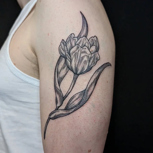 Medium Black and Grey Tulip Tattoo on Women Shoulder by @laurabeatricetattoo