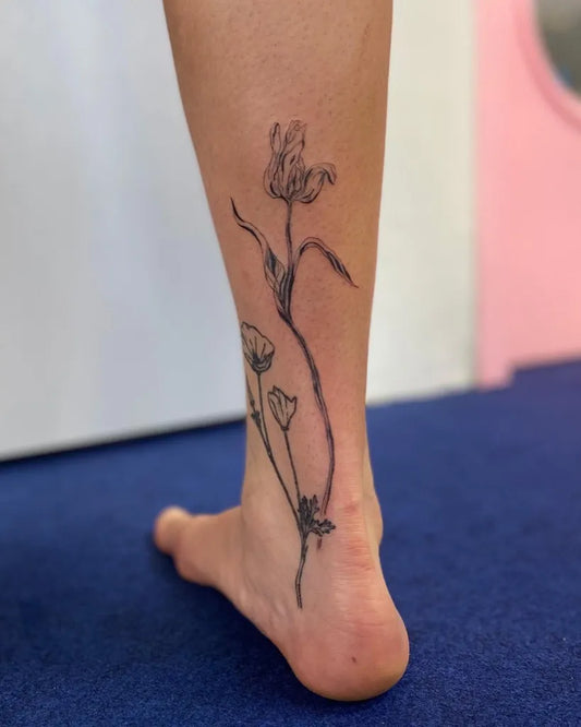 Medium Black and Grey Tulip and Buds Tattoo on Women Leg by @nao.tattoo_