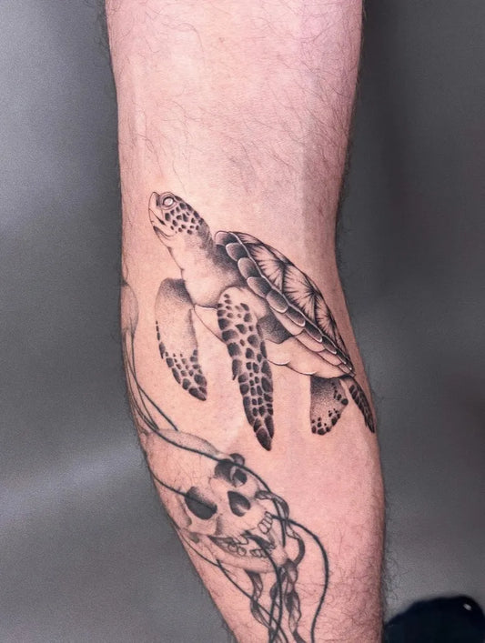 Medium Black and Grey Turtle and Skull Tattoo on Men Leg by @anngravure