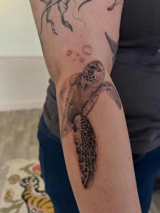 Medium Black and Grey Turtle and Tentacles Tattoo on Women Arm by @daisyduketattooist