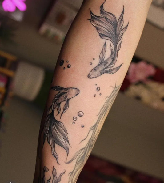 Medium Black and Grey Two Betta Fish Tattoo on Women Arm by @brandnewtattoo