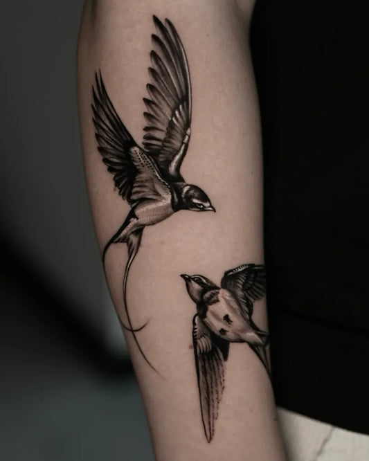 Medium Black and Grey Two Flying Birds Tattoo on Women Arm by @lucidcreationstattoo