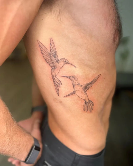 Medium Black and Grey Two Hummingbirds Tattoo on Men Rib by @xtinamariaart