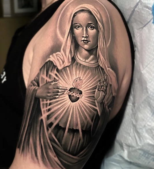 Medium Black and Grey Virgin Mary Sacred Heart Tattoo on Women Shoulder by @delmer_tattoo_shop