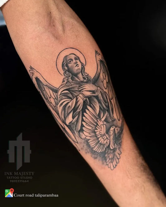 Medium Black and Grey Virgin Mary with Angel Wings Tattoo on Men Arm by @tattoo_ink_majesty_taliparamba