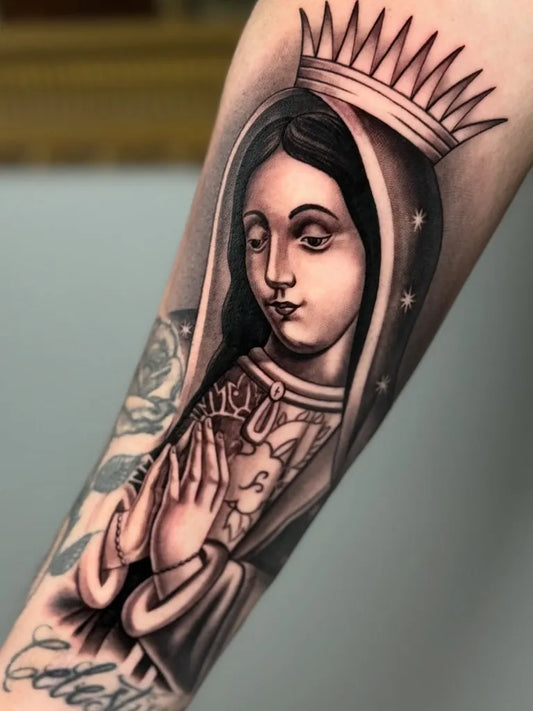 Medium Black and Grey Virgin Mary with Crown and Roses Tattoo on Women Arm by @tattoosbysergiomendez
