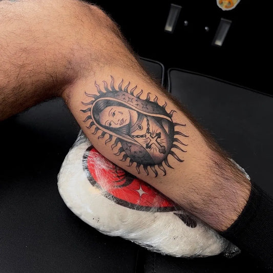 Medium Black and Grey Virgin Mary with Halo and Rosary Tattoo on Men Thigh by @tattoostattooshop