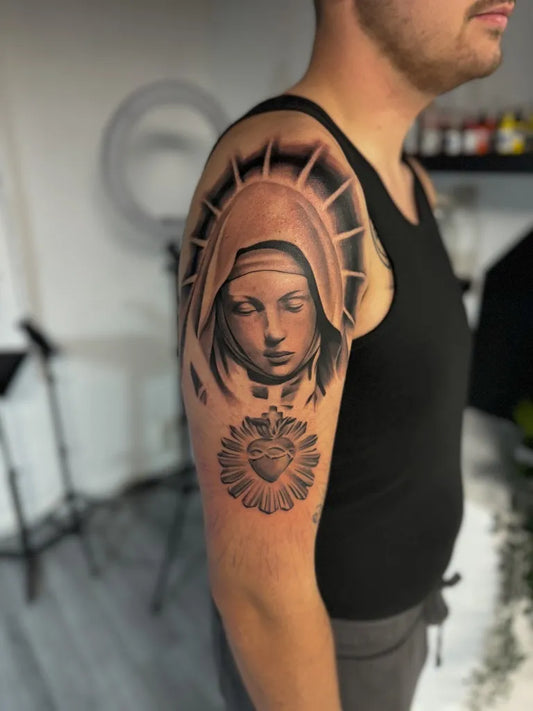 Medium Black and Grey Virgin Mary with Sacred Heart Tattoo on Men Upper Arm by @jordy_lenaerts_tattoo