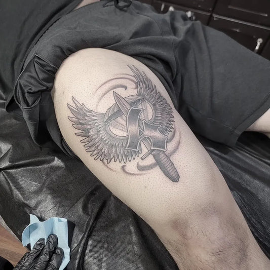Medium Black and Grey Winged Dagger Military Tattoo on Men Thigh by @tattoolenny
