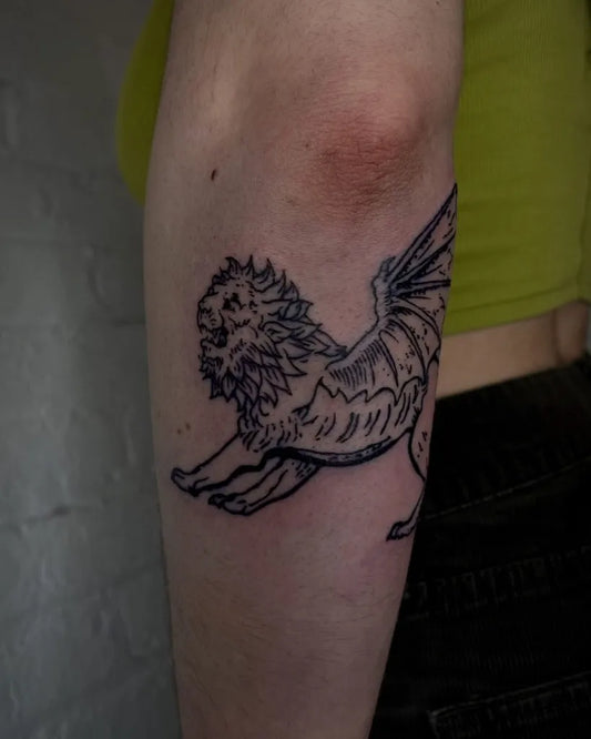 Medium Black and Grey Winged Lion Tattoo on Women Elbow by @stucknstoked