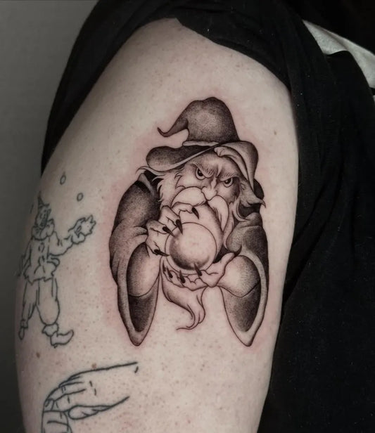 Medium Black and Grey Wizard with Orb Cartoon Tattoo on Men Arm by @keeler_ink
