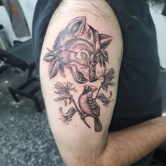 Medium Black and Grey Wolf Bird and Lilies Tattoo on Men Bicep by @_lydiathetattoolady