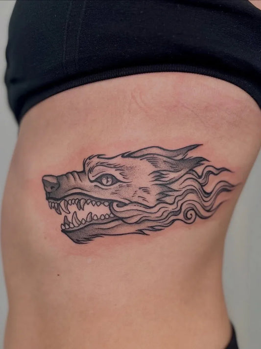 Medium Black and Grey Wolf Head on Women Ribs Tattoo by @charlot.tattoo