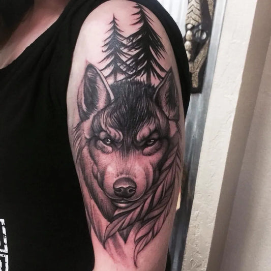 Medium Black and Grey Wolf and Trees Nature Tattoo on Women Arm by @emeraldtattoomodesto