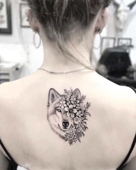 Medium Black and Grey Wolf with Flowers on Women Back Tattoo by @callyjoart