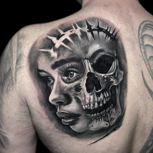 Medium Black and Grey Woman Face with Skull Tattoo on Men Back by @holytrinitytattoos