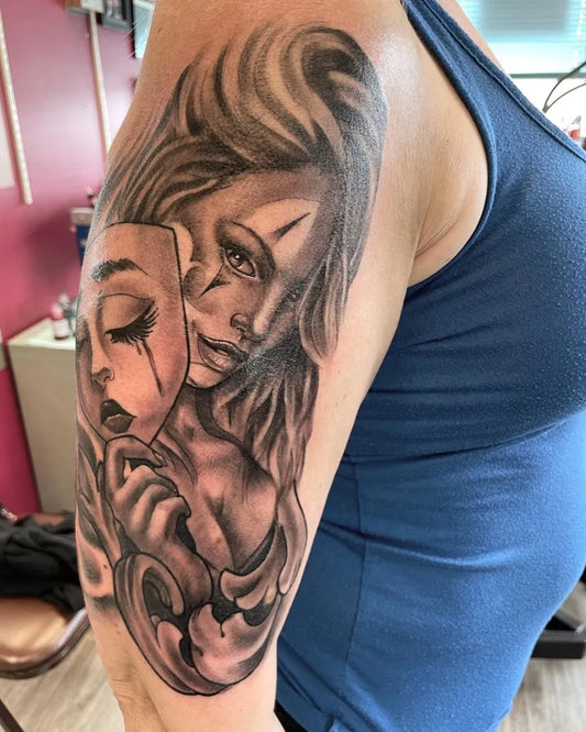 Medium Black and Grey Woman with Tragedy Comedy Masks Tattoo on Women Bicep by @richwithcolor