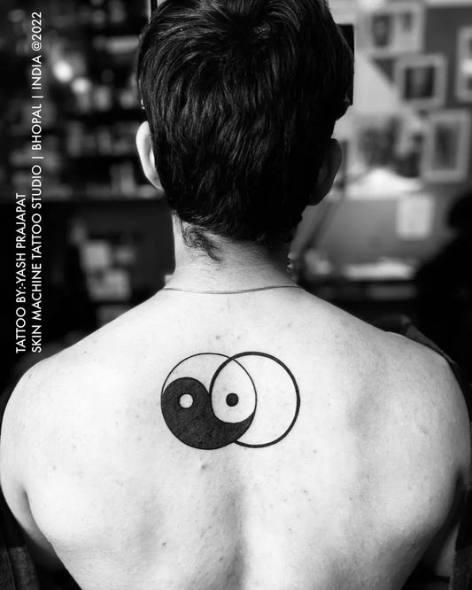 Medium Black and Grey Yin Yang Circle Tattoo on Men Back by @skinmachinetattoo