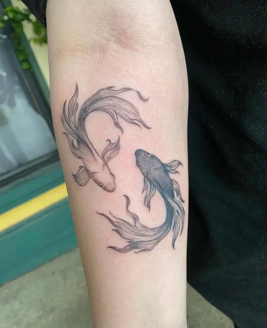 Medium Black and Grey Yin Yang Koi Pisces Tattoo on Women Arm by @esperanzainktattoos