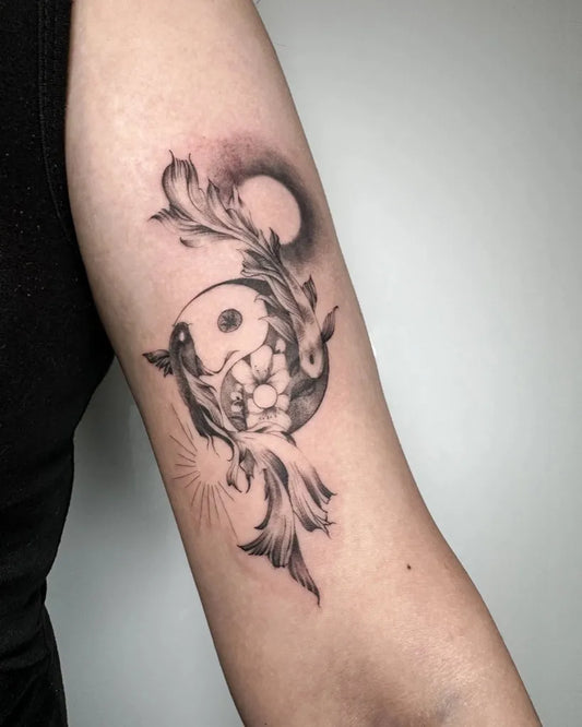 Medium Black and Grey Yin Yang Koi Tattoo on Women Arm by @descriptive_art_collective