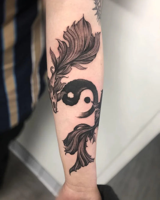 Medium Black and Grey Yin Yang Koi Tattoo on Women Arm by @toji_tattoo_studio