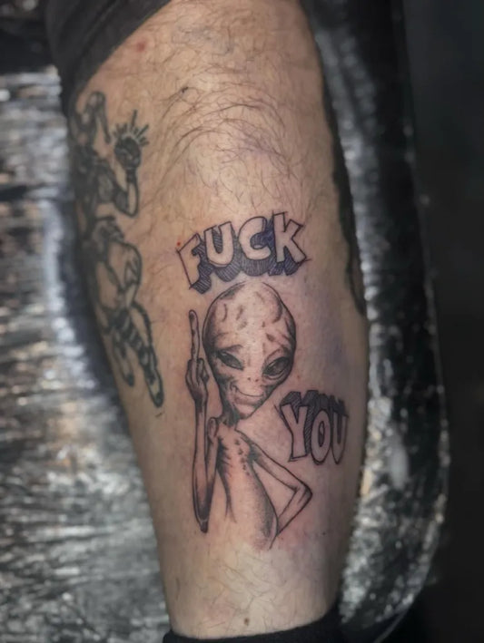 Medium Blackwork Alien Giving Middle Finger Tattoo on Men Leg by @alexmtattoos