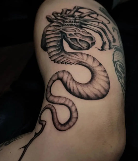Medium Blackwork Alien Snake Tattoo on Men Arm by @sailorstattoomilanoduomo