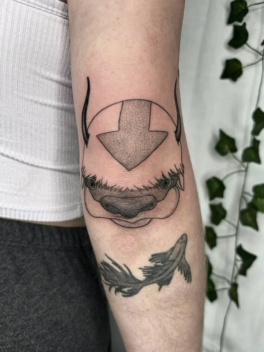 Medium Blackwork Appa and Koi Cartoon Tattoo on Women Arm by @maggiecampanellitattoos