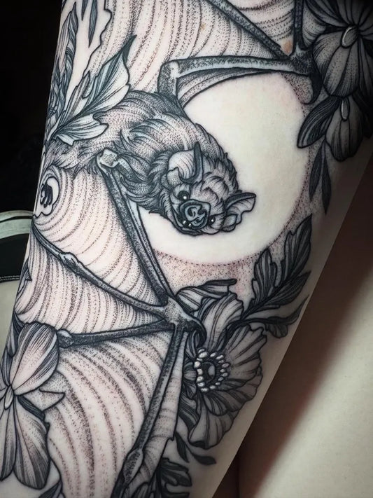 Medium Blackwork Bat Moon Flowers Tattoo on Women Arm by @bexpriesttattoos