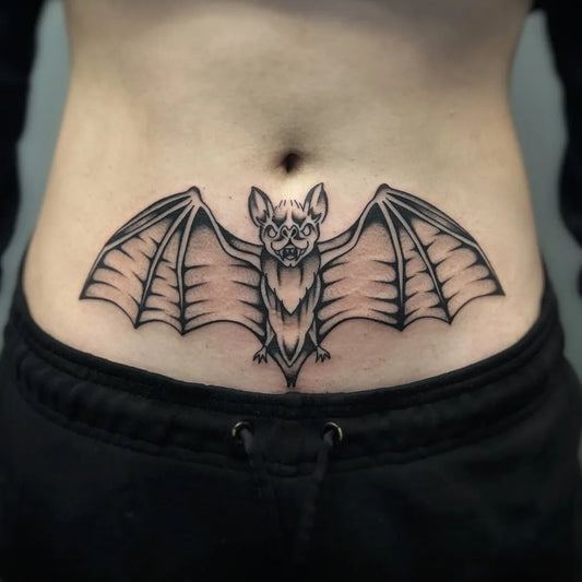 Medium Blackwork Bat Tattoo on Women Stomach by @sauravtattoos