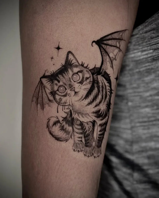Medium Blackwork Bat Winged Cat Tattoo on Women Arm by @mochitats