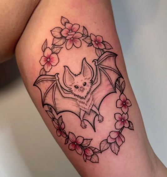 Medium Blackwork Bat and Flowers Tattoo on Women Arm by @rebelwithacausetattoo._