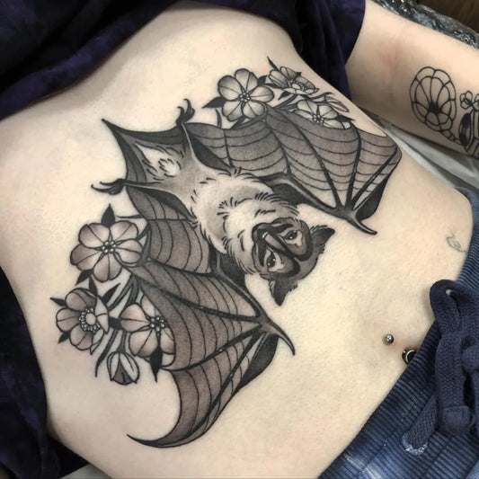 Medium Blackwork Bat and Flowers Tattoo on Women Stomach by @ania_bodz