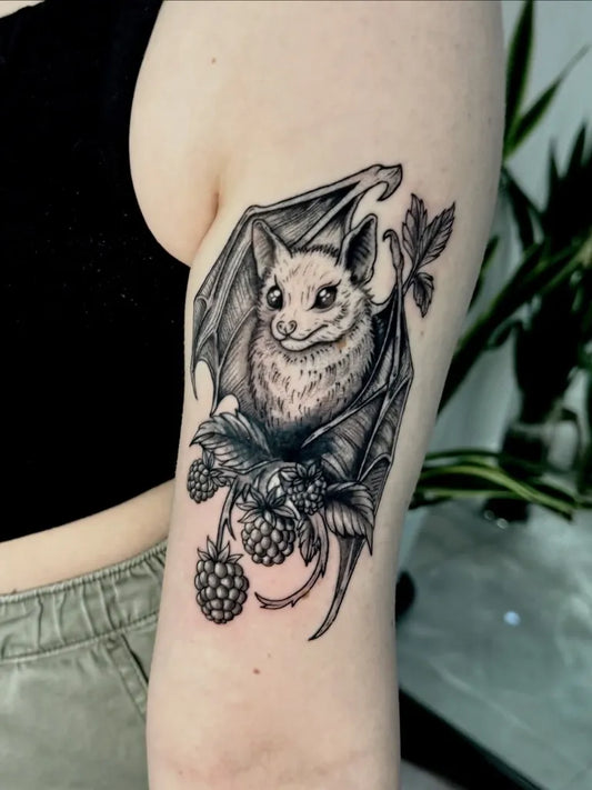 Medium Blackwork Bat with Berries Tattoo on Women Arm by @thallis_inktattoo