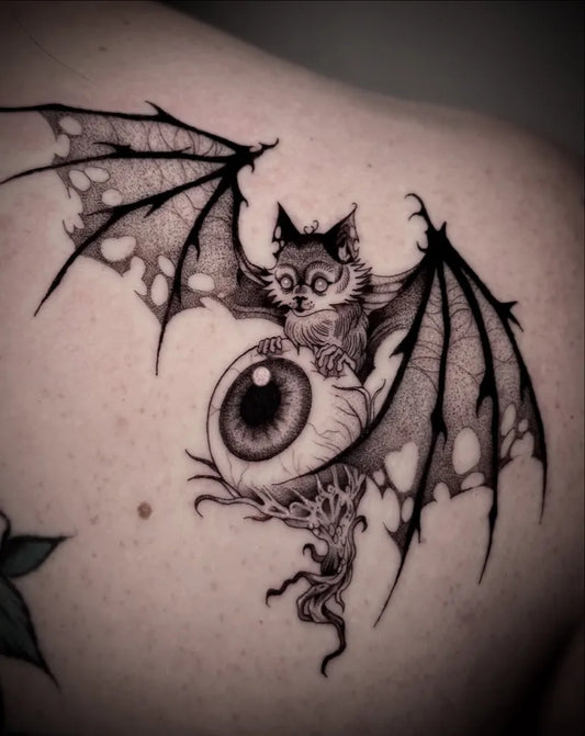 Medium Blackwork Bat with Eyeball Women Shoulder by @mochitats