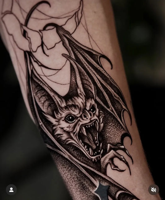 Medium Blackwork Bat with Wings Tattoo on Men Arm by @lucidcreationstattoo