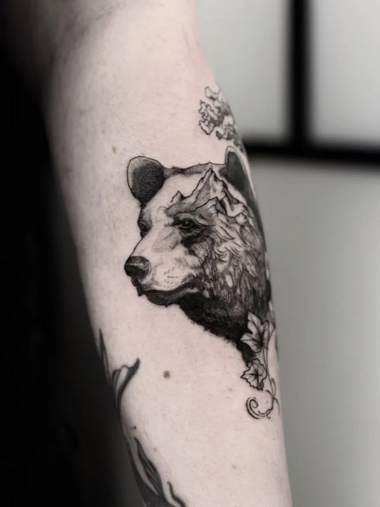 Medium Blackwork Bear with Flowers Women Arm by @olgahassan.tattoo