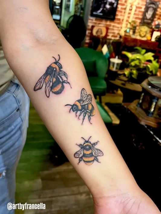Medium Blackwork Bee Cluster on Women Arm Tattoo by @dreadfulthingstattoo