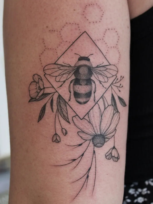 Medium Blackwork Bee and Flowers on Women Arm Tattoo by @theartofeverett