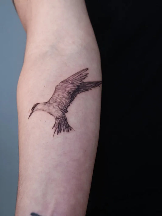 Medium Blackwork Bird Tattoo on Women Arm by @hep_aom