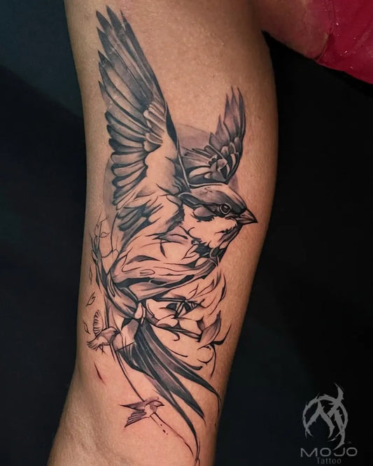 Medium Blackwork Bird and Flowers Tattoo on Men Arm by @mojo_tattoo_studio_bangalore