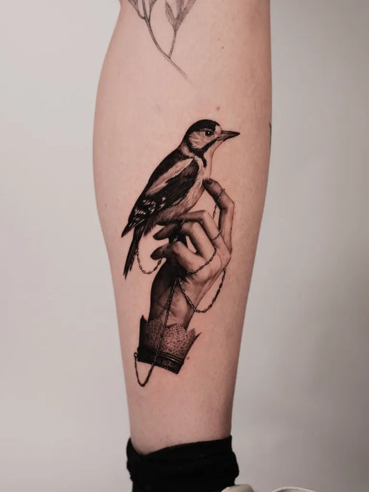 Medium Blackwork Bird and Hand Tattoo on Women Leg by @jankyjake_tattoos