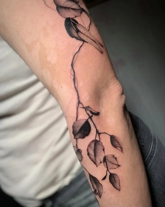Medium Blackwork Bird and Leaves Nature Tattoo on Men Arm by @pepperinflame_tattoo