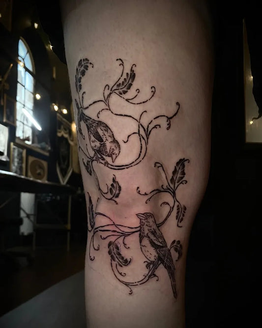 Medium Blackwork Birds and Vines Tattoo on Women Knee by @tattoos_by_lizzie