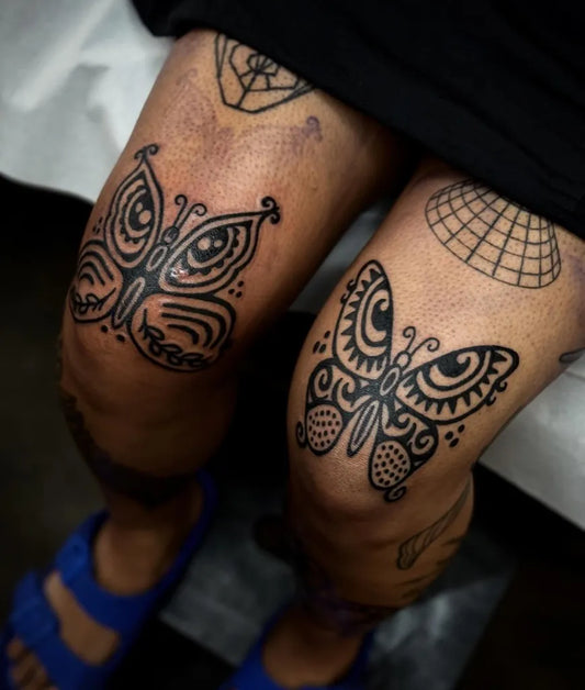 Medium Blackwork Butterfly Tattoo on Women Knee by @zibal.tattow