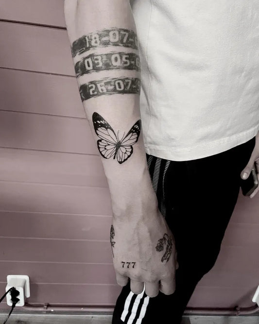 Medium Blackwork Butterfly and 777 Tattoo on Men Arm by @rutjes_ink