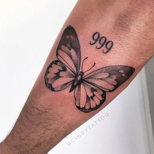 Medium Blackwork Butterfly and 999 Tattoo on Men Arm by @cindytattoo_ink