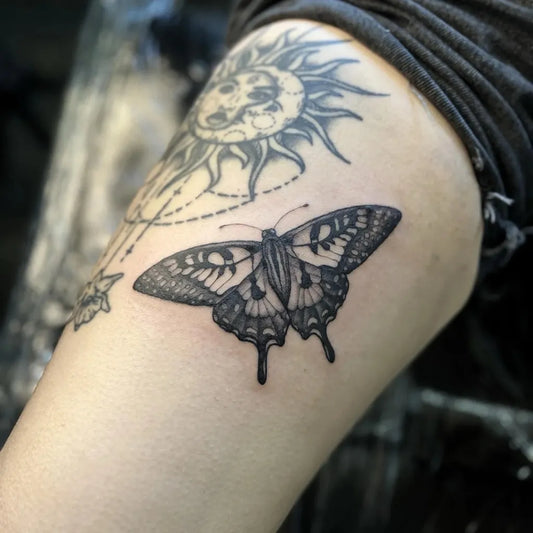 Blackwork Butterfly and Sun on Women Upper Arm Tattoo by @coventattoouk