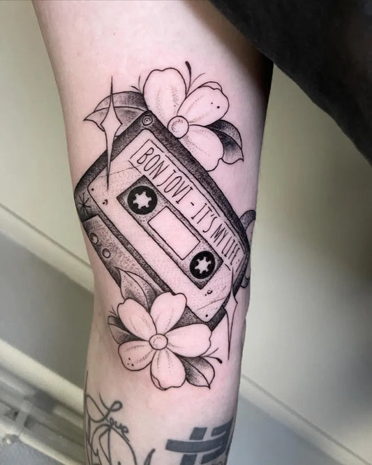 Medium Blackwork Cassette and Flowers Music Tattoo on Women Thigh by @sheisametz.tattoo